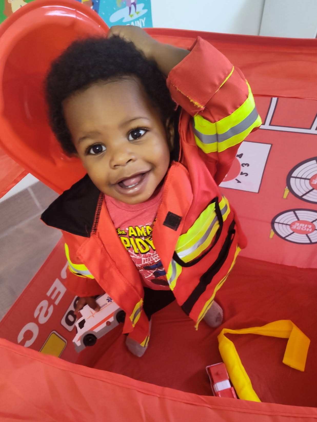 A smiling child enjoying imaginative firefighter play